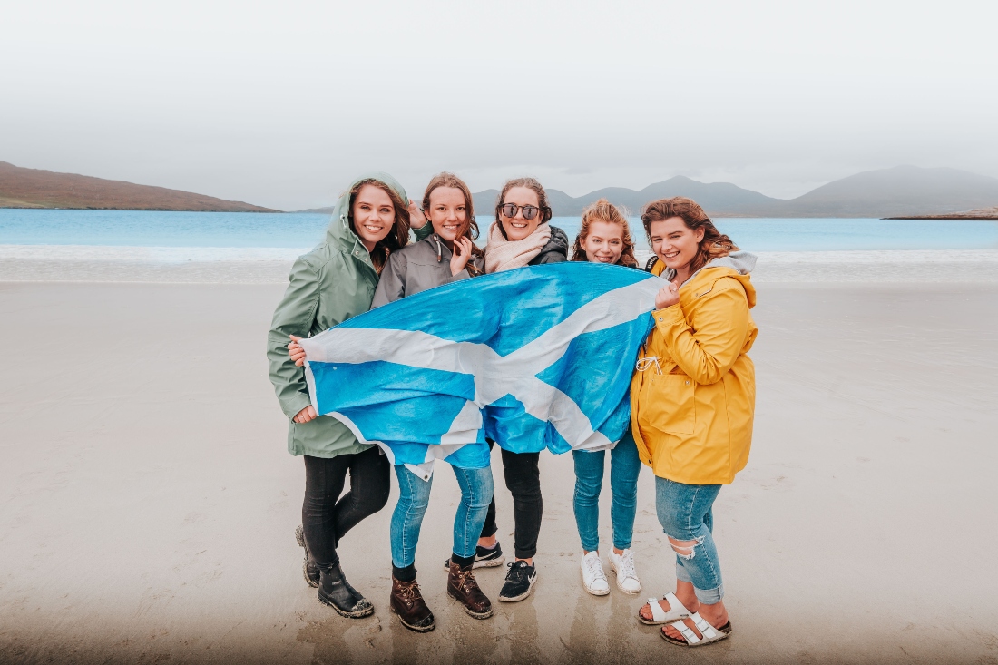 Passengers with a Scotland flag on Luskentyre Beach